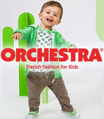 A young boy is posing for the orchestra logo.