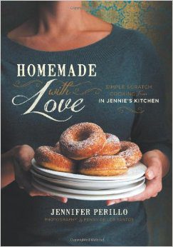 A woman holding a plate of doughnuts with the words homemade with love written on it.