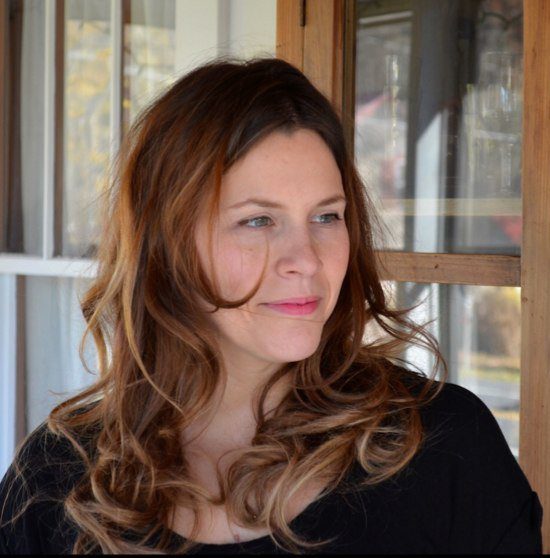 A woman with long brown hair wearing black.