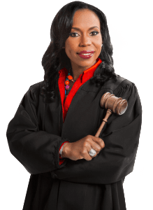 A woman in black robe holding a gavel.