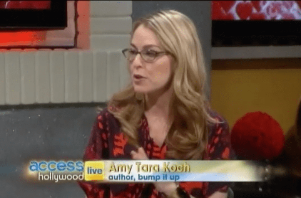 A woman in glasses and red shirt talking on the set of success live.