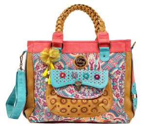 A colorful handbag with a bow and flower on it.